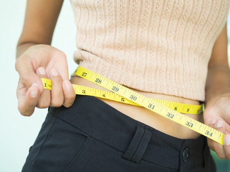 Waist woman with tape measure.